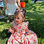 toddler, child, girl, confetti, flower_dress, grass, outdoor, sunlight, playing, party, candy, pigtails, people, shoes, boots, greenery, daylight, smiling, celebration, fun