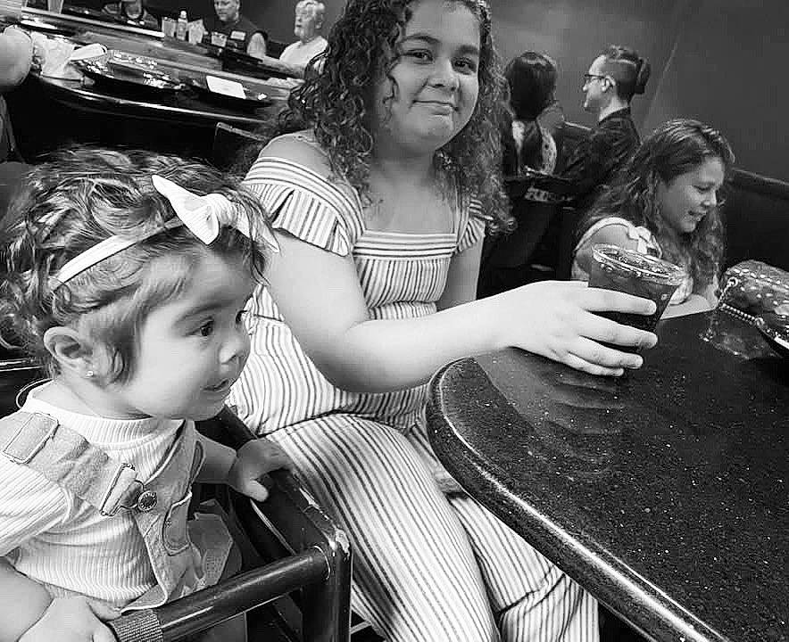 Swayze joined the competition — help win amazing prizes! black, black_and_white, chair, face, facial_expression, fashion, fun, hair, hairstyle, happy, headwear, interaction, joy, people, person, photograph, sharing, smile, style, table