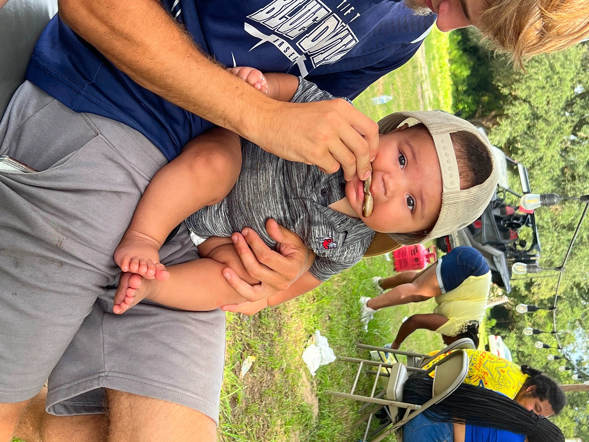 Dawson is registered to the contest to win money with this photo: baby, baby_products, child, competition_event, event, fun, gesture, grass, happy, hat, headwear, leisure, person, plant, recreation, shorts, t_shirt, toddler, tree, vacation