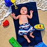 Braxton joined the competition — help win amazing prizes! baby, beach, towel, sand, water, waves, toy, bucket, shovel, boat, fish, shorts, child, summer, play, outdoor, ocean, sea, barefoot, relax