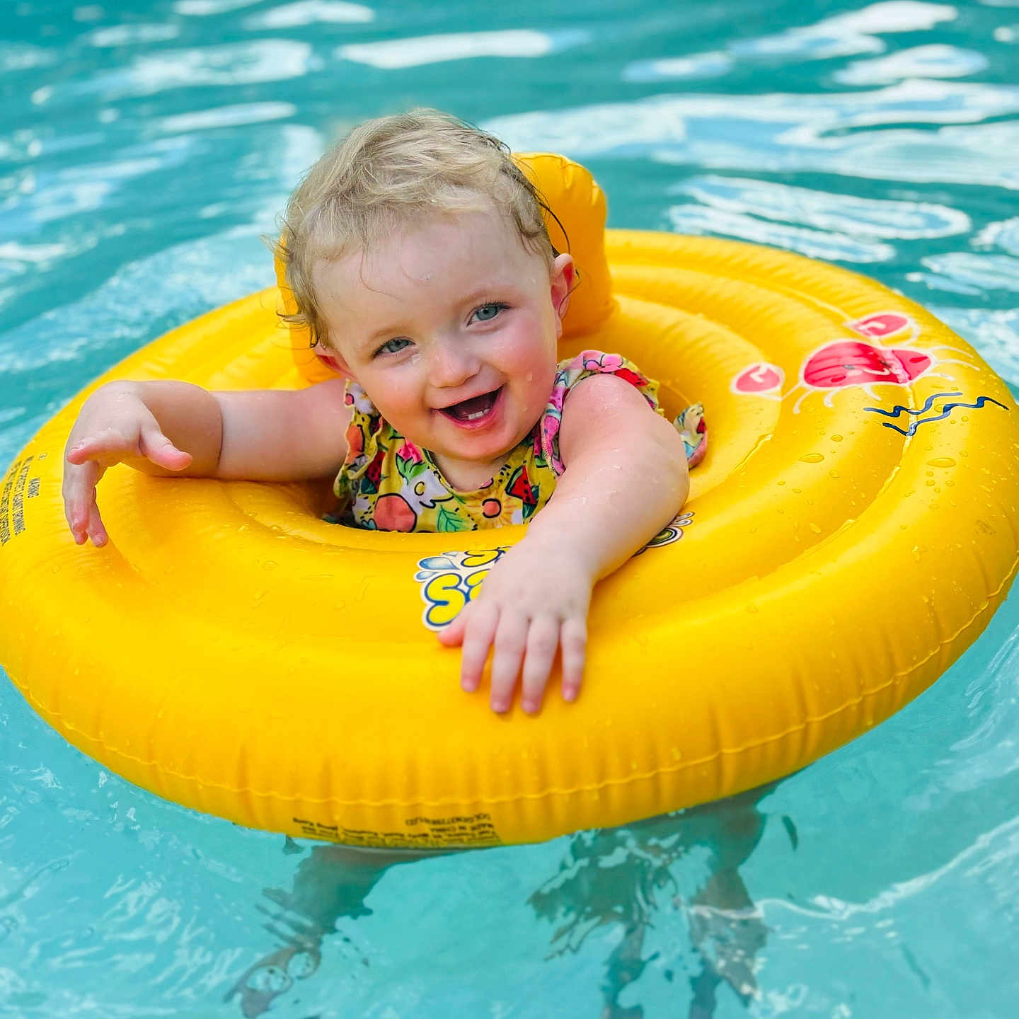 Rylee is registered to the contest to win money with this photo: baby, clothing, face, happy, head, leisureactivities, lifejacket, outdoors, person, photography, pool, portrait, sport, summer, swimming, swimmingpool, swimwear, vest, water, watersports