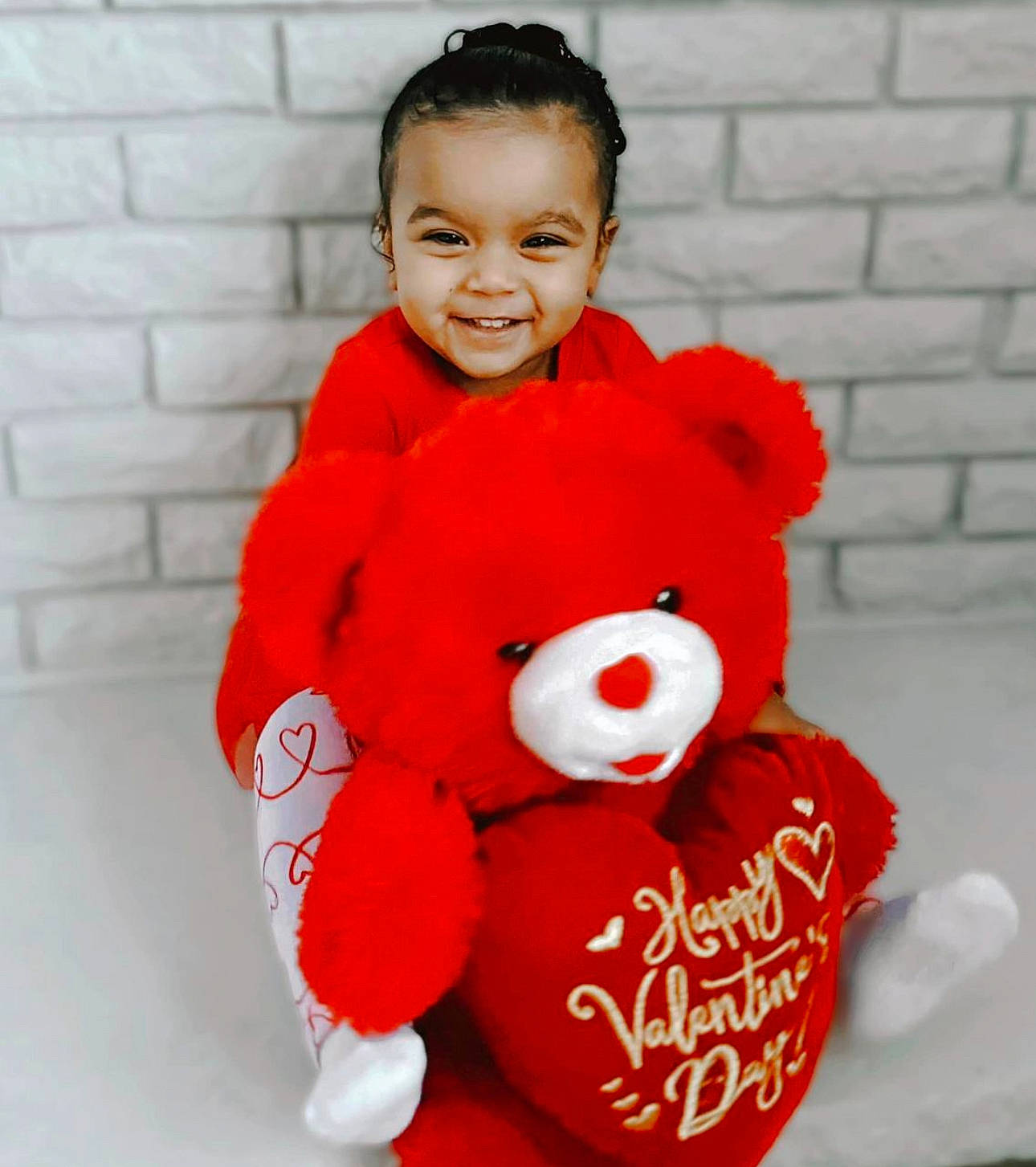 Daniela joined the competition — help win amazing prizes! baby_toddler_clothing, bear, brick, child, font, fur, happy, head, holiday, joy, orange, peach, person, plush, red, sleeve, smile, stuffed_toy, teddy_bear, toddler