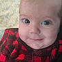 baby, child, face, eyes, smile, red_clothing, plaid, cozy, closeup, infant, cute, portrait, indoors, warm, soft_light, young, person, apparel, expression, head