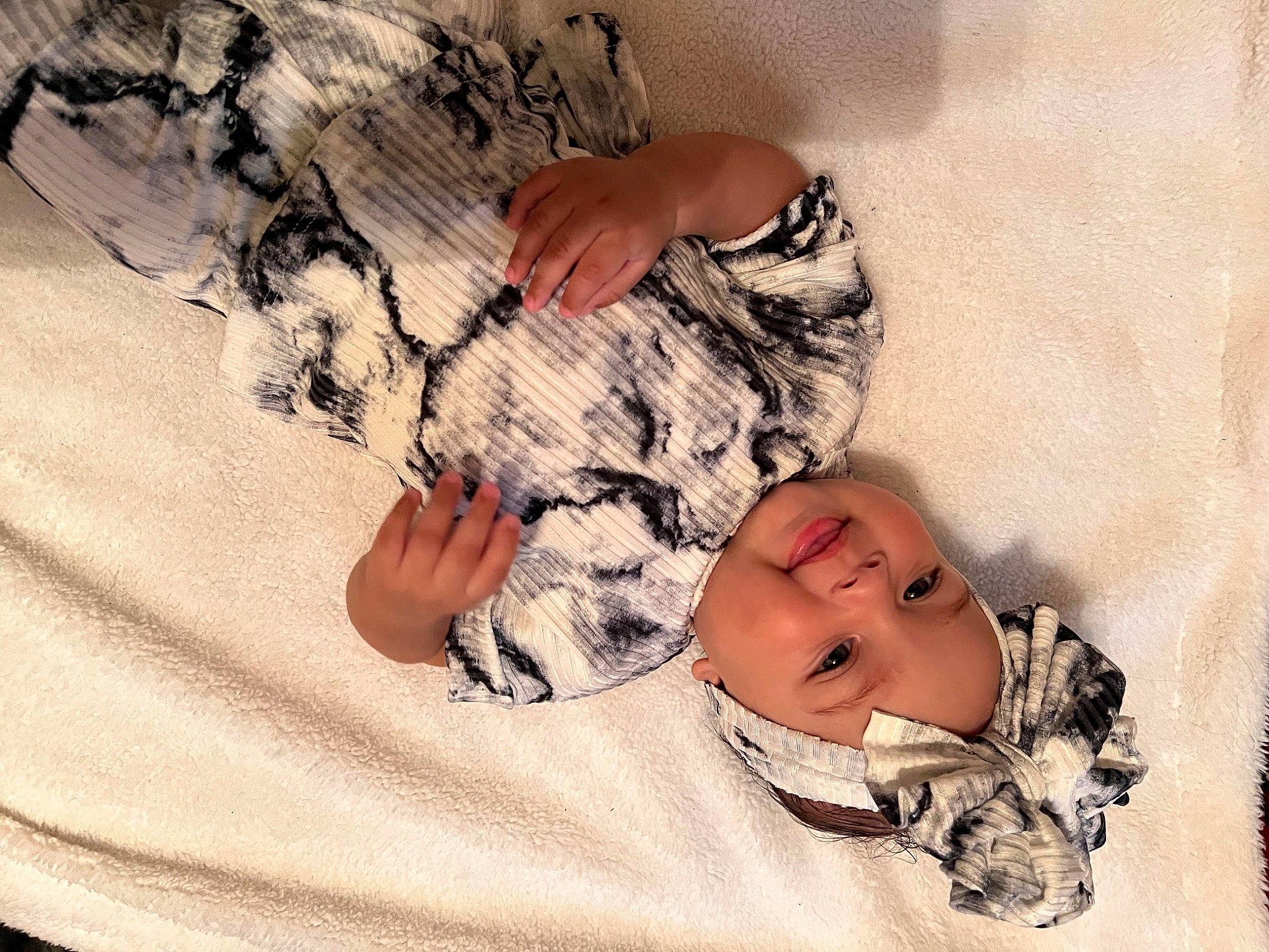 Alaina is registered to the contest to win money with this photo: baby, baby_sleeping, baby_toddler_clothing, child, comfort, finger, flooring, gesture, hand, happy, headwear, human_body, joy, linens, pattern, person, skin, sleeve, textile, thigh