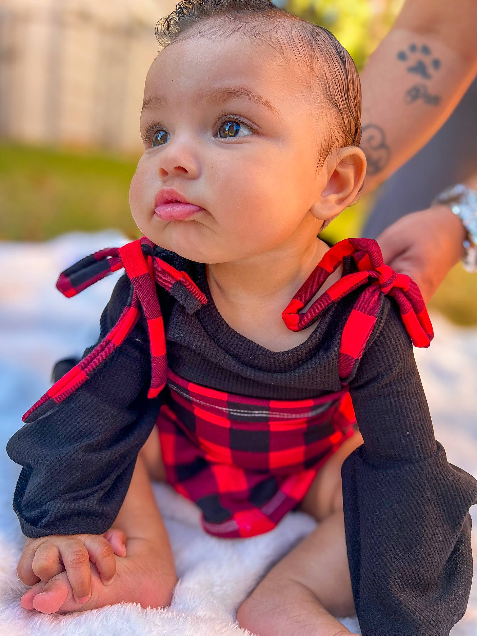 Alaina joined the competition — help win amazing prizes! arm, baby, baby_toddler_clothing, child, dress, eye, fashion_accessory, grass, hand, happy, head, lip, pattern, person, plaid, red, sitting, skin, sleeve, tartan