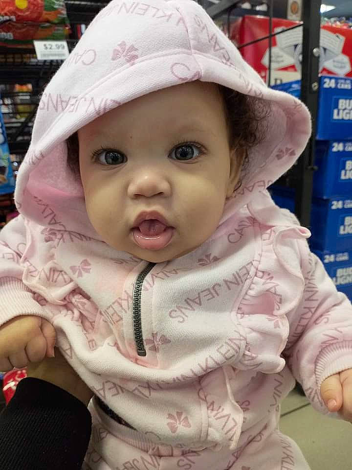 Aloncia is registered to the contest to win money with this photo: baby, baby_toddler_clothing, cap, cheek, child, eye, eyelash, fashion_accessory, fun, happy, hat, headgear, headwear, lip, mouth, nose, person, pink, sitting, skin