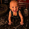 baby, infant, smiling, dirt, wrench, mechanic_theme, tools, motor_oil, tire, nuts, clothing, overalls, face, hands, floor, sign, rustic, happy, portrait, indoors