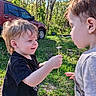 Waylon is registered to the contest to win money with this photo: child, children, outdoor, nature, dandelion, grass, trees, sunlight, toy, bucket, red_vehicle, casual_clothing, interaction, smile, happy, summer, greenery, person, play, friendship