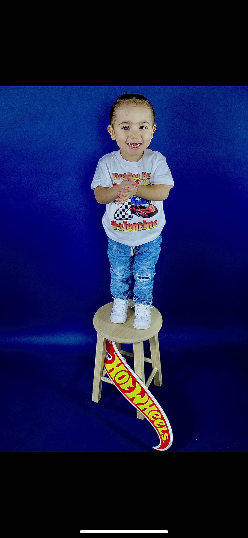 Valentino is registered to the contest to win money with this photo: baby_toddler_clothing, blue, child, denim, electric_blue, event, flash_photography, font, fun, happy, human_leg, joy, logo, person, recreation, sitting, sleeve, smile, standing, t_shirt