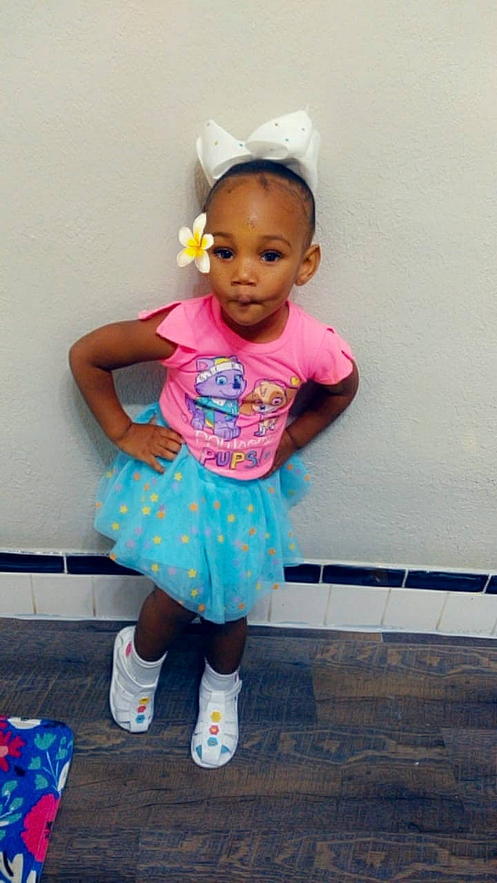 Amilyah is registered to the contest to win money with this photo: baby, baby_products, baby_toddler_clothing, child, clothing, costume, hair_accessory, headband, person, pink, play, shoe, smile, toddler, turquoise