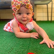 Scotlynn is registered to the contest to win money with this photo: baby, child, headband, floral, dress, toy, carpet, green, smiling, cute, indoors, person, face, hand, play, infant, happy, colorful, portrait, young