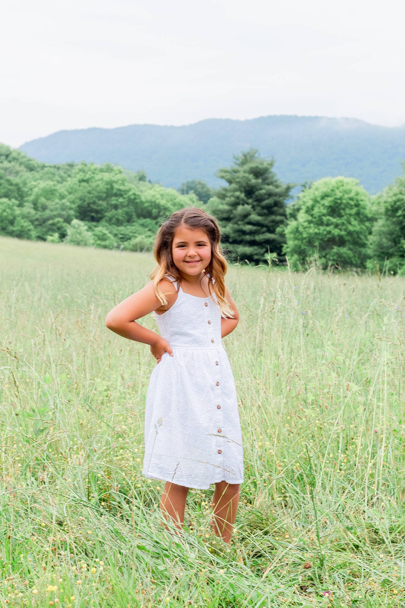 Brynlee is registered to the contest to win money with this photo: agriculture, brown_hair, day_dress, dress, ecoregion, grass, grass_family, grassland, happy, joy, landscape, meadow, mountain, natural_landscape, people_in_nature, person, plain, plant, prairie, sky
