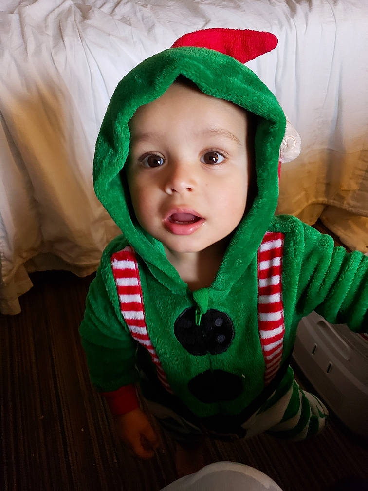 Layton joined the competition — help win amazing prizes! baby, baby_toddler_clothing, cap, carmine, child, christmas, christmas_eve, costume_hat, event, fictional_character, fun, grass, green, happy, headwear, holiday, human_body, outerwear, person, sleeve