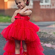 Melissa Maria is registered to the contest to win money with this photo: child, girl, red_dress, dress, tulle, ribbons, headband, smile, posing, outdoor, street, brick_wall, fashion, portrait, happy, cute, feet, socks, earrings, young