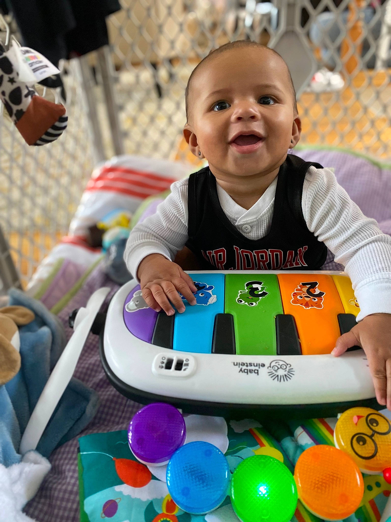Deangelo is registered to the contest to win money with this photo: baby, baby_playing_with_toys, baby_toddler_clothing, child, event, fun, green, happy, human, leisure, people, person, photograph, product, recreation, smile, snapshot, t_shirt, toddler, toy