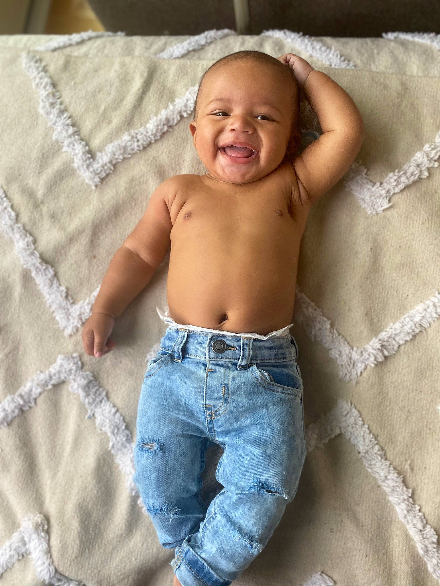 Deangelo is registered to the contest to win money with this photo: abdomen, baby, barechested, chest, comfort, denim, electric_blue, human_leg, jeans, joy, linens, pattern, person, skin, sleeve, smile, stomach, textile, thigh, toddler