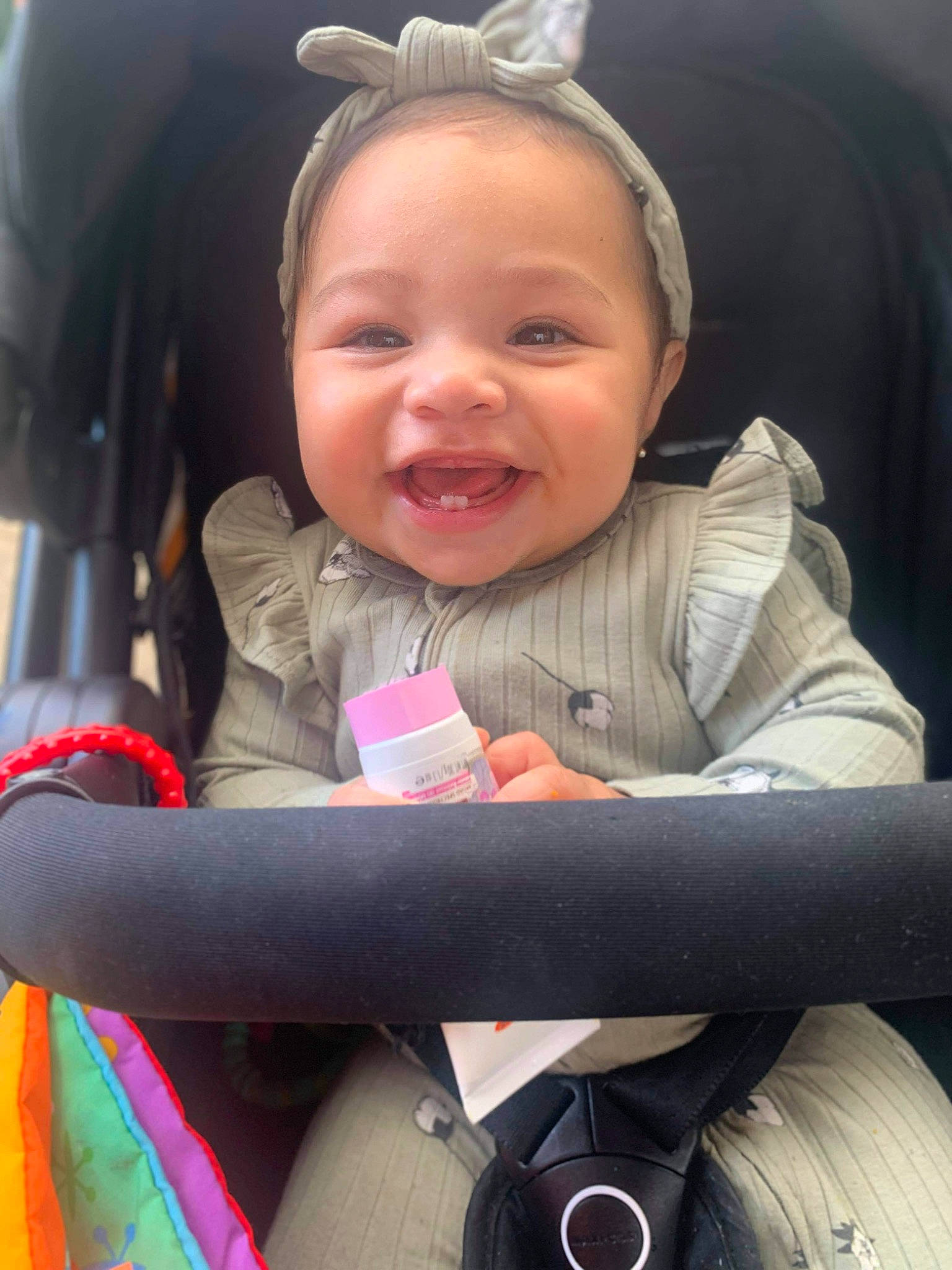 Jayleen is registered to the contest to win money with this photo: baby_carriage, black, cheek, comfort, face, facial_expression, finger, happy, head, human, iris, lip, mouth, person, pink, product, skin, smile, toddler, wheel