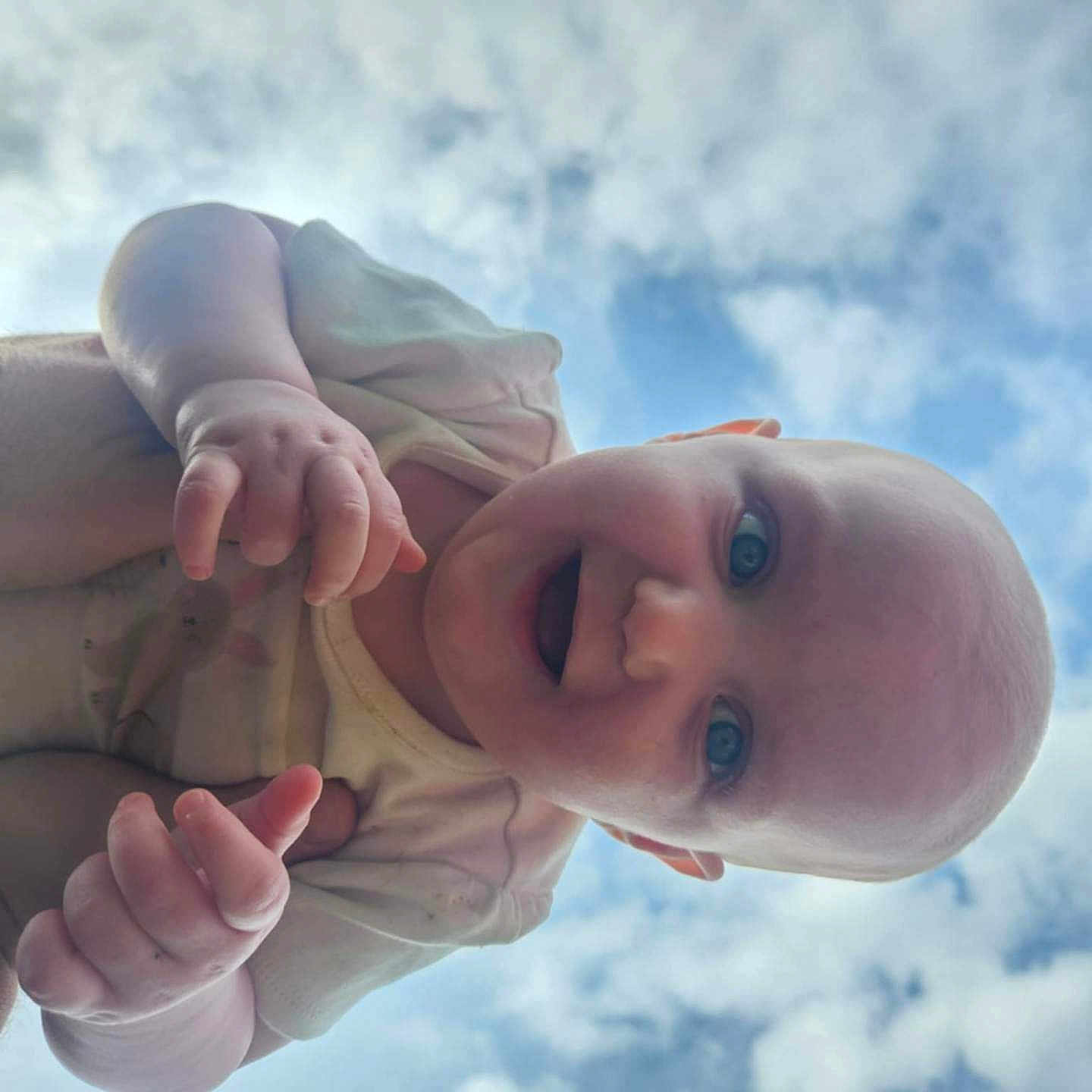 Carleigh is registered to the contest to win money with this photo: baby, babylaughing, bodypart, clothing, cloud, face, finger, hand, happy, hat, head, laughing, nature, newborn, outdoors, person, photography, portrait, sky, smile
