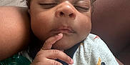 Kamazi joined the competition — help win amazing prizes! baby, sleeping, hand, face, person, clothing, pacifier, cute, infant, curly_hair, skin, comfort, child, closeup, resting, peaceful, indoors, fabric, holding, peace