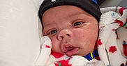 Jamari is registered to the contest to win money with this photo: baby, beanie, blanket, child, closeup, clothing, colorful, cozy, cute, face, hat, indoors, infant, nike, pillow, portrait, resting, soft, warm, young