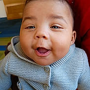 Jamari is registered to the contest to win money with this photo: baby, child, smiling, happy, face, knitted_sweater, clothing, indoor, portrait, cute, person, infant, young_child, head, expression, warm_clothing, closeup, eyes, mouth, cozy