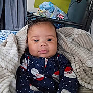 Jamari is registered to the contest to win money with this photo: baby, bedroom, blanket, child, clothing, cozy, cute, face, hands, happy, indoors, infant, onesie, person, plush, portrait, santa_claus, smile, soft, warm