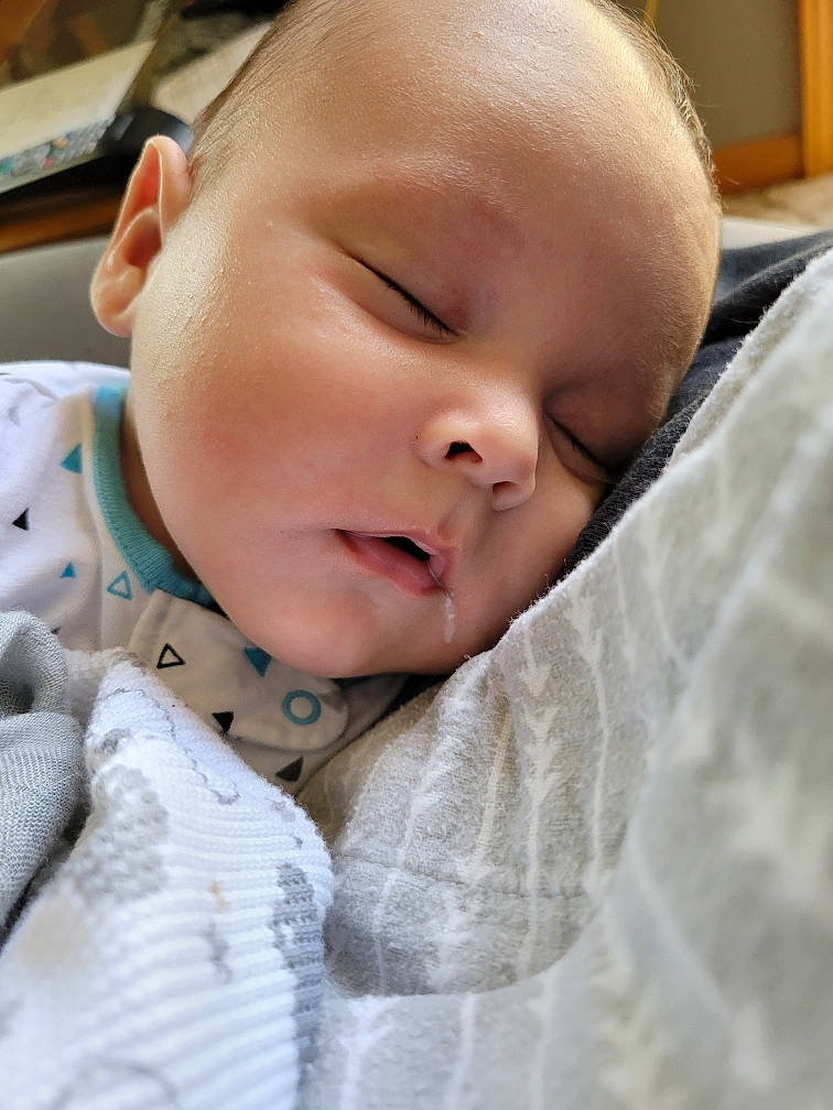 Davian is registered to the contest to win money with this photo: baby, baby_toddler_clothing, bedtime, cheek, child, comfort, eyelash, grass, happy, iris, linens, nose, pattern, person, portrait_photography, skin, toddler