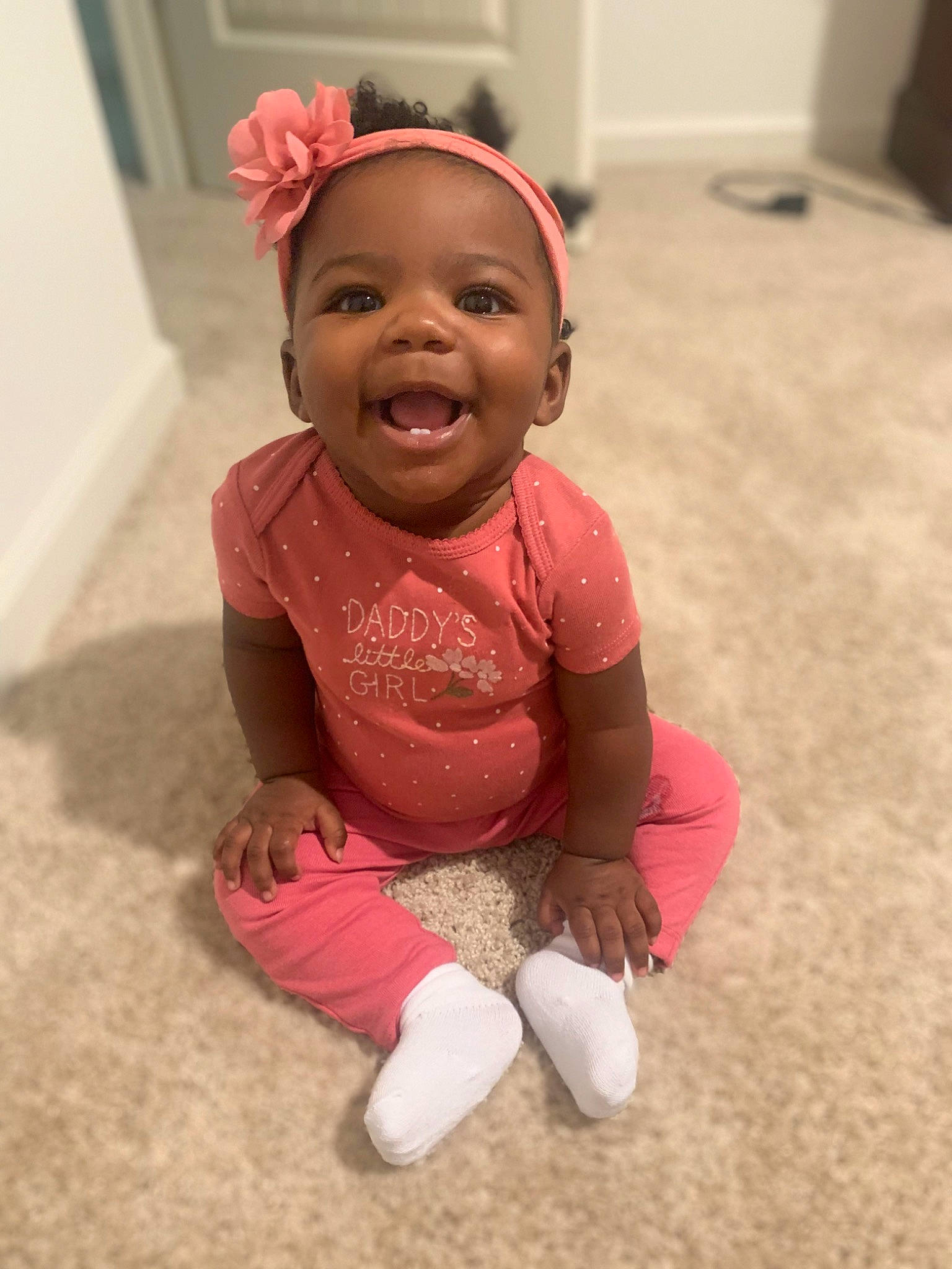 Kiara is registered to the contest to win money with this photo: baby, baby_toddler_clothing, cheek, clothing, eye, floor, flooring, fun, happy, head, human_body, human_leg, magenta, nose, person, pink, skin, sleeve, smile, sock