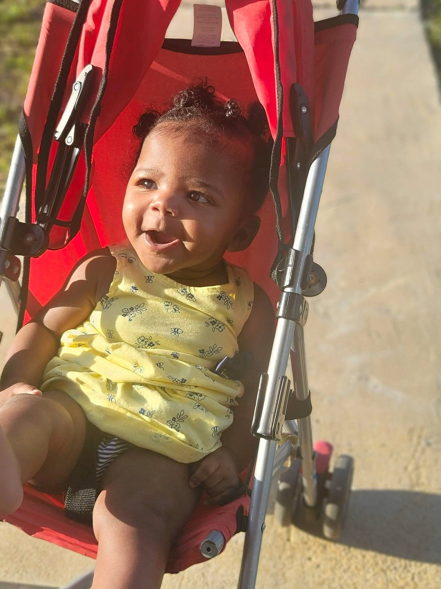 Kiara is registered to the contest to win money with this photo: baby, baby_carriage, baby_products, chair, child, eye, facial_expression, fun, happy, human_leg, leisure, person, play, recreation, shorts, sitting, skin, thigh, tire, toddler