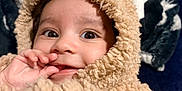 Elias joined the competition — help win amazing prizes! baby, child, face, eyes, hand, clothing, costume, hood, fluffy, beige, cute, portrait, smile, cozy, blanket, soft, indoor, warm, infant, person