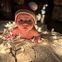 Wylder is registered to the contest to win money with this photo: baby, santa_hat, christmas_lights, blanket, infant, holiday, bokeh, glowing, cute, toddler, indoors, warm_lighting, face, expression, child, festive, soft_texture, closeup, curious, decorative_lights