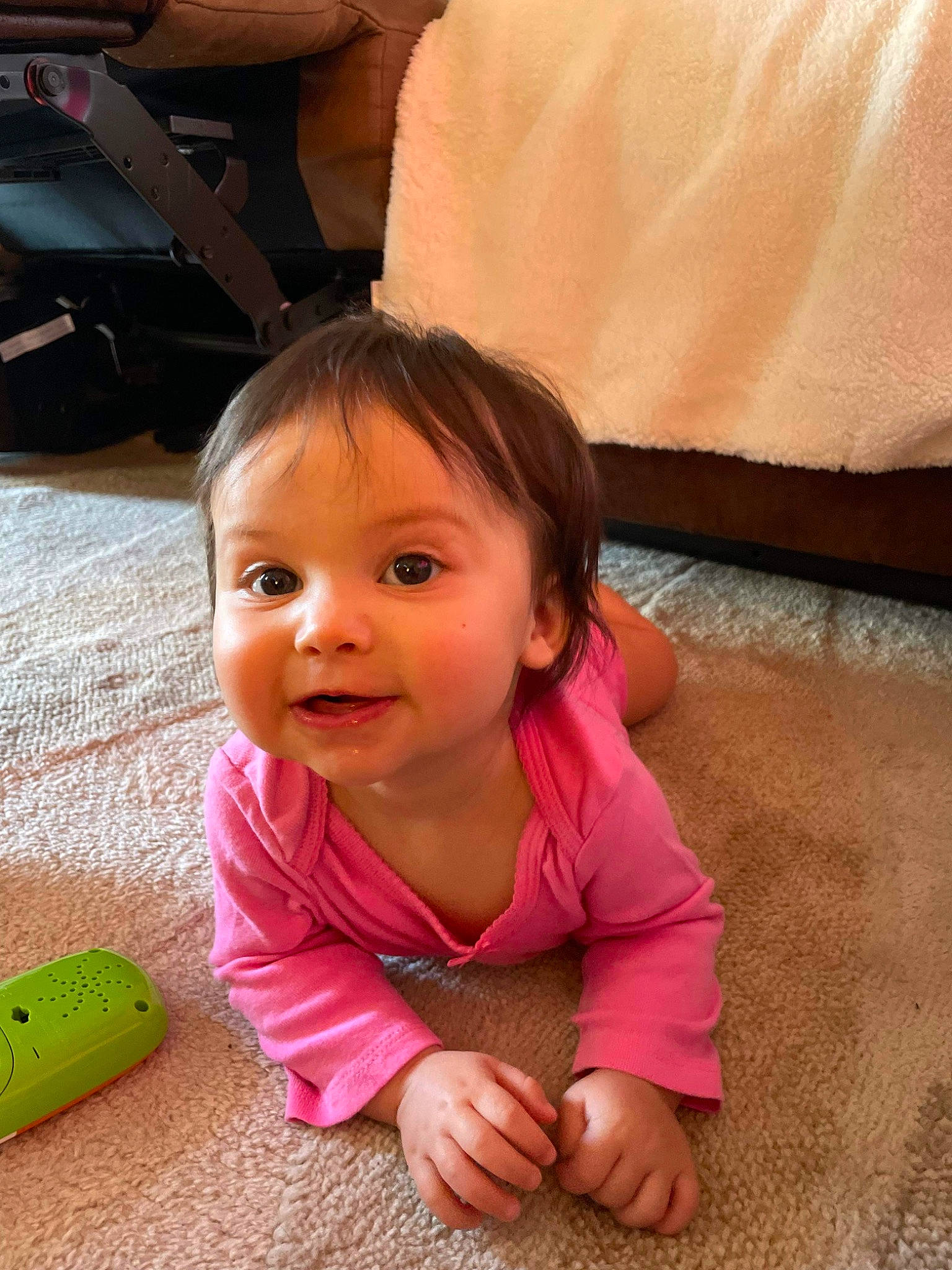 Freya is registered to the contest to win money with this photo: baby, baby_toddler_clothing, cheek, child, comfort, finger, floor, flooring, fun, happy, leisure, nose, person, pink, skin, smile, thumb, toddler, toy, travel