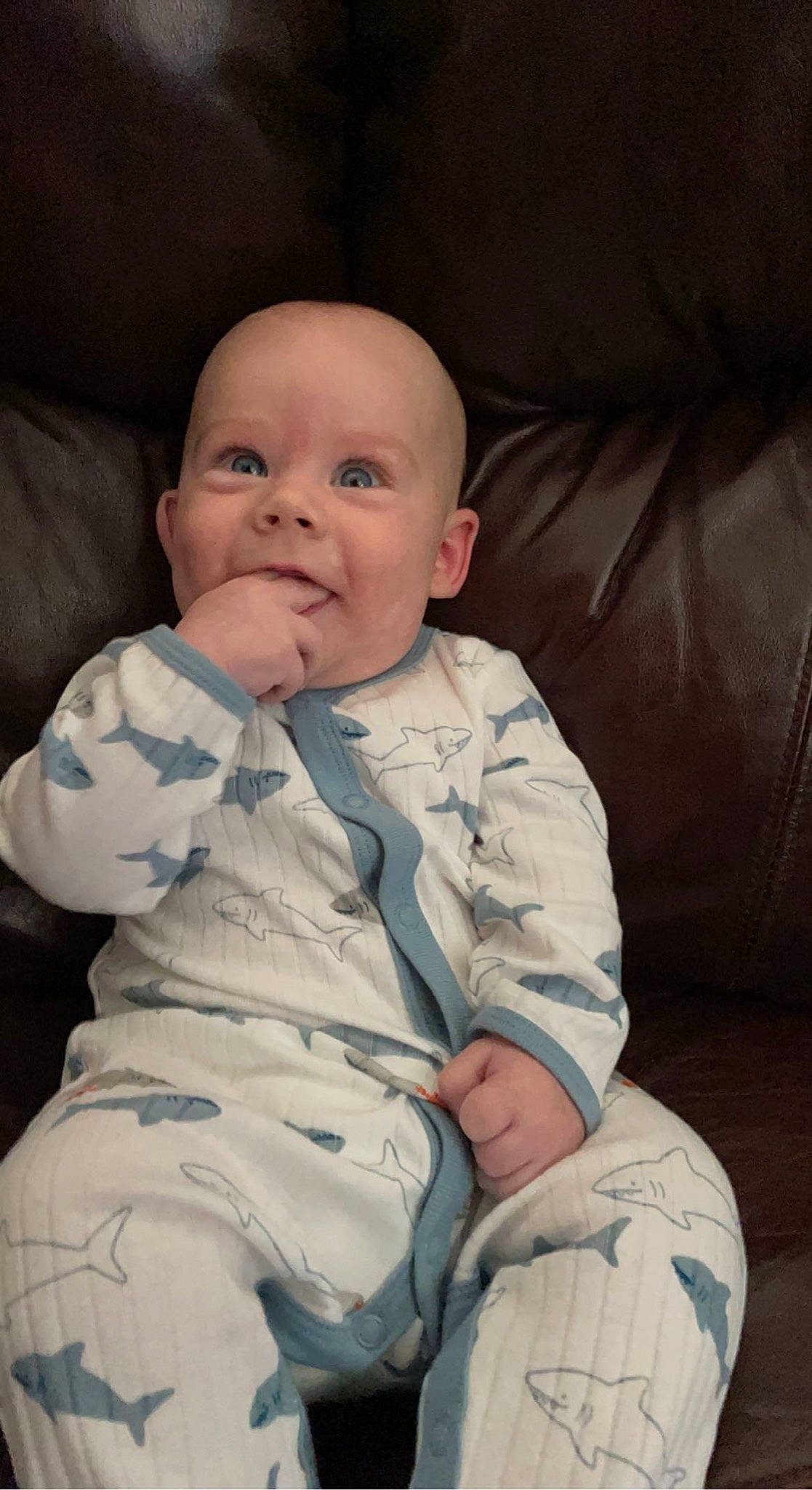 Jackson is registered to the contest to win money with this photo: baby, baby_toddler_clothing, cheek, child, chin, comfort, couch, eye, finger, iris, linens, lip, mouth, nose, person, room, sitting, skin, sleeve, smile