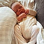 baby, bed, blanket, child, closeup, comfort, cozy, cute, indoors, infant, newborn, peaceful, person, pillow, portrait, resting, sleeping, soft_texture, warm, white_outfit