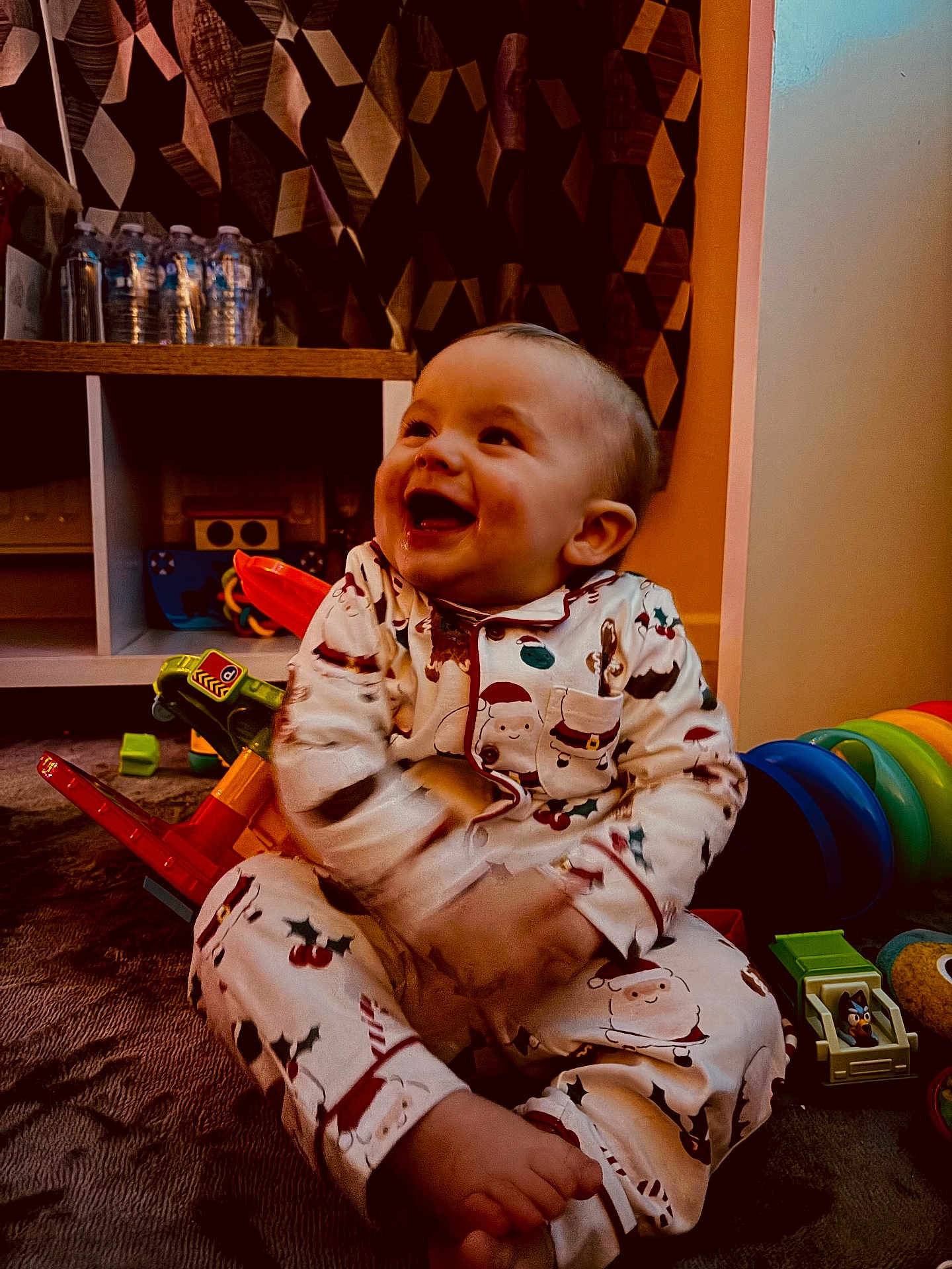 Marley- Jay joined the competition — help win amazing prizes! baby, child, smiling, pajamas, toys, floor, indoor, happy, cute, playtime, colorful, sitting, face, person, home, carpet, shelf, bottle, curtain, infant