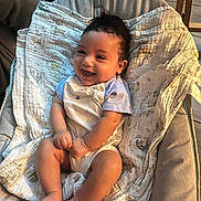 Saul joined the competition — help win amazing prizes! baby, bare_feet, blanket, chair, child, clothing, cushion, cute, happy, home, indoor, infant, laughing, onesie, portrait, sitting, smiling, sunlight, toes, warm_lighting