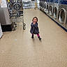Manzanita joined the competition — help win amazing prizes! child, toddler, laundromat, washing_machine, dryer, floor, smile, clothing, pink_leggings, grey_dress, running, happy, indoor, cart, metal, laundry, appliance, person, cleaning, joy