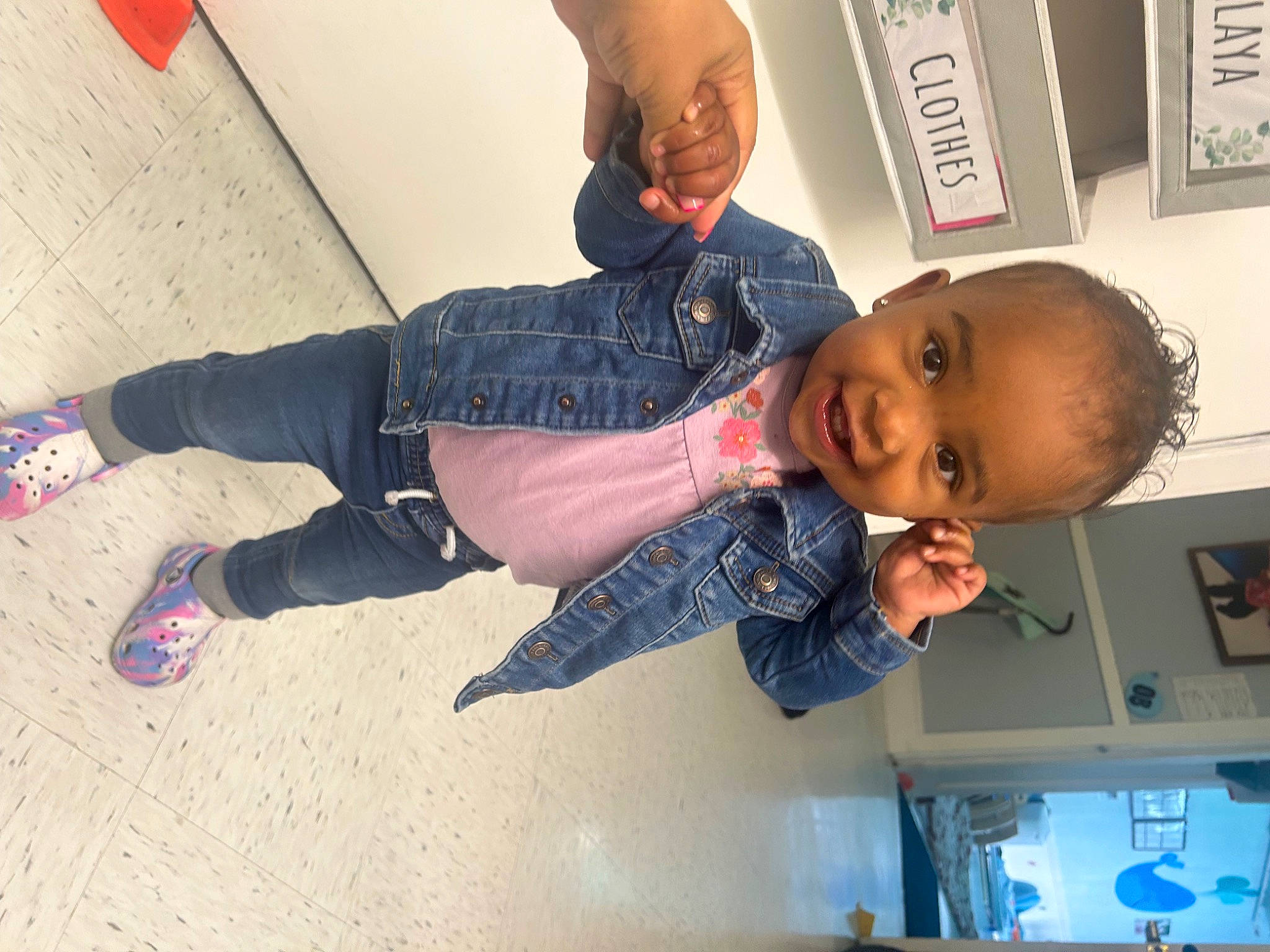 Amya is registered to the contest to win money with this photo: baby, child, elbow, flooring, foot, fun, happy, human_leg, joint, joy, knee, person, picture_frame, play, room, sandal, smile, sock, t_shirt, thigh