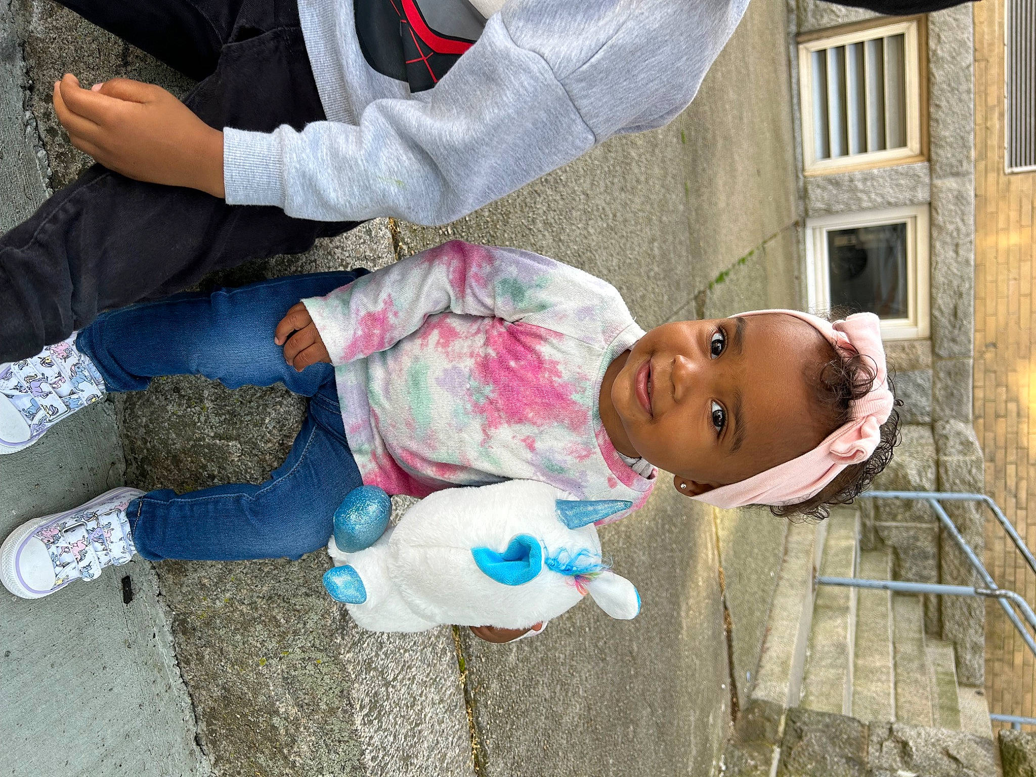 Amya is registered to the contest to win money with this photo: building, child, fun, hat, house, human_leg, joy, leisure, person, plastic, sitting, toddler, window