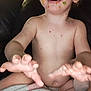 toddler, child, face, hands, blanket, food, messy, indoor, couch, smiling, skin, curly_hair, cheerful, playful, person, baby, expression, seat, comfort, casual