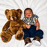 baby, teddy_bear, plaid_shirt, navy_pants, brown_shoes, sleeping, soft_blanket, cute, infant, toy, cozy, child, lying_down, indoors, portrait, adorable, peaceful, plush, baby_fashion, resting