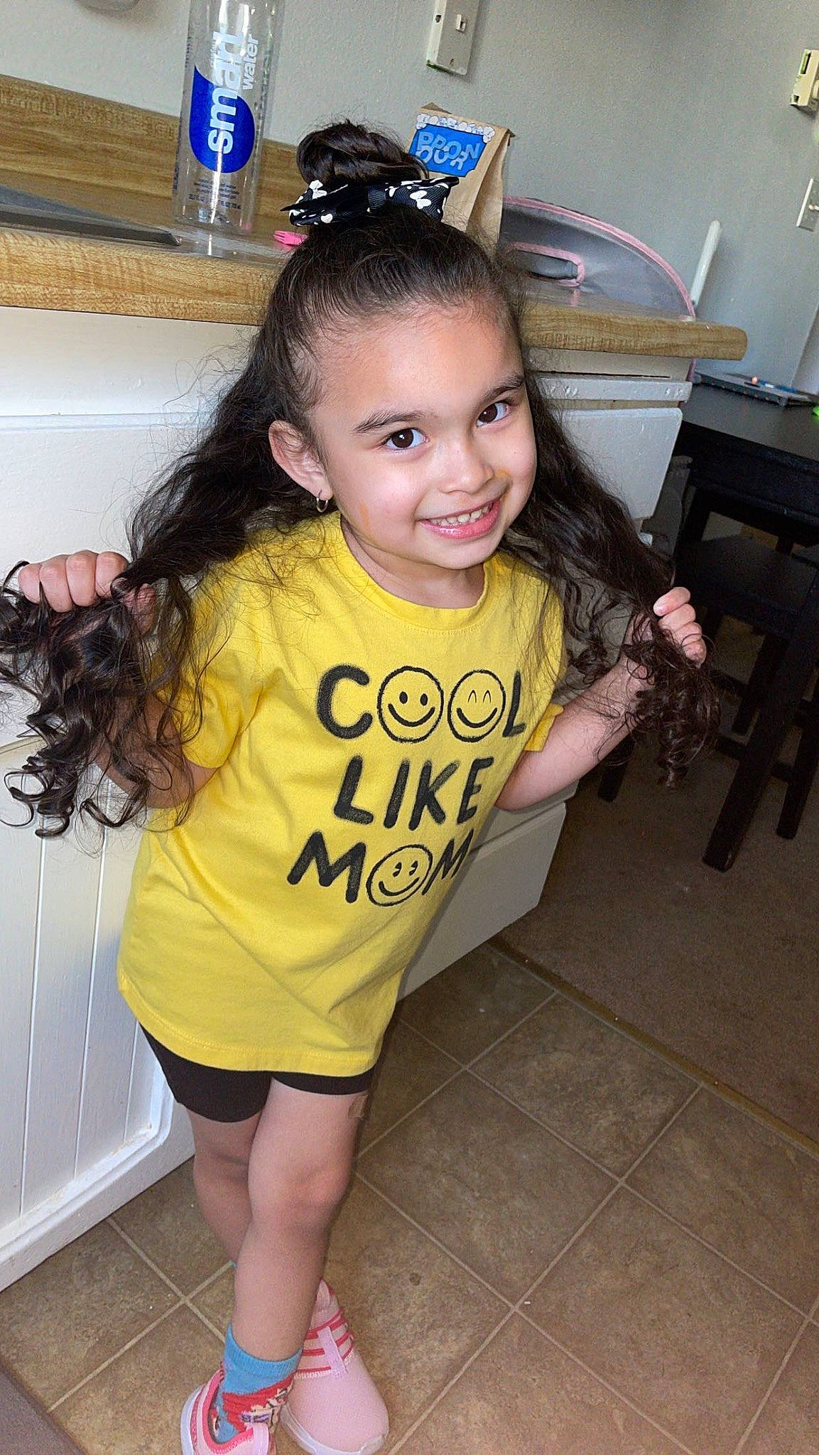 Adelyne is registered to the contest to win money with this photo: black_hair, chair, child, cool, eye, flooring, fun, happy, headpiece, human_leg, joy, long_hair, person, shorts, skin, sleeve, smile, sportswear, t_shirt, thigh
