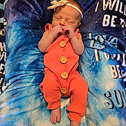 Addison joined the competition — help win amazing prizes! newborn, baby, sleeping, orange_outfit, headband, blanket, blue, buttons, infant, cozy, cute, peaceful, soft, small_feet, tiny_hands, portrait, indoors, comfort, rest, child