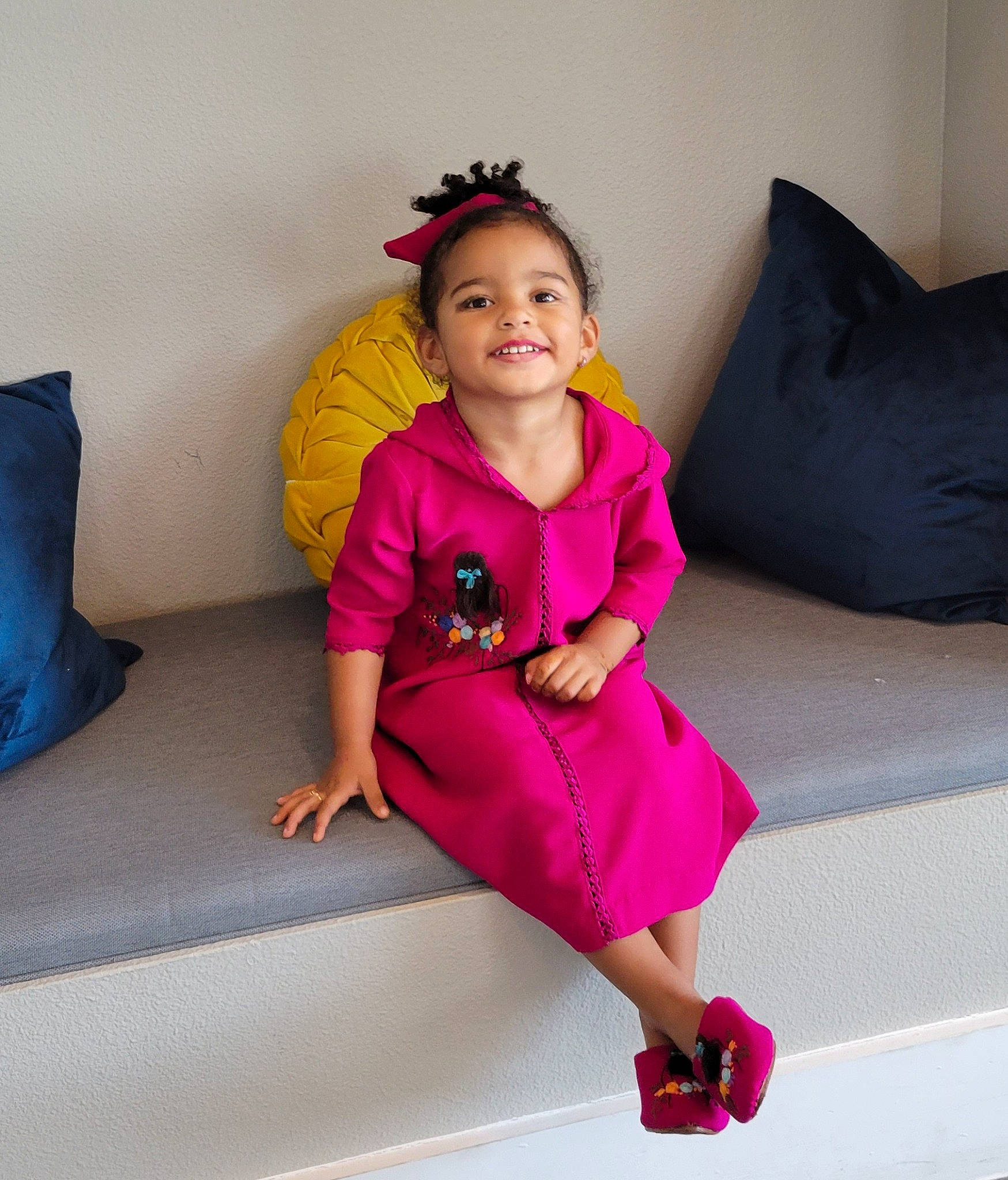 Lylia joined the competition — help win amazing prizes! baby_toddler_clothing, clothing, comfort, couch, dress, fashion_design, flooring, hair, hairstyle, hand, happy, human_body, joy, magenta, person, pink, purple, shoulder, sleeve, smile
