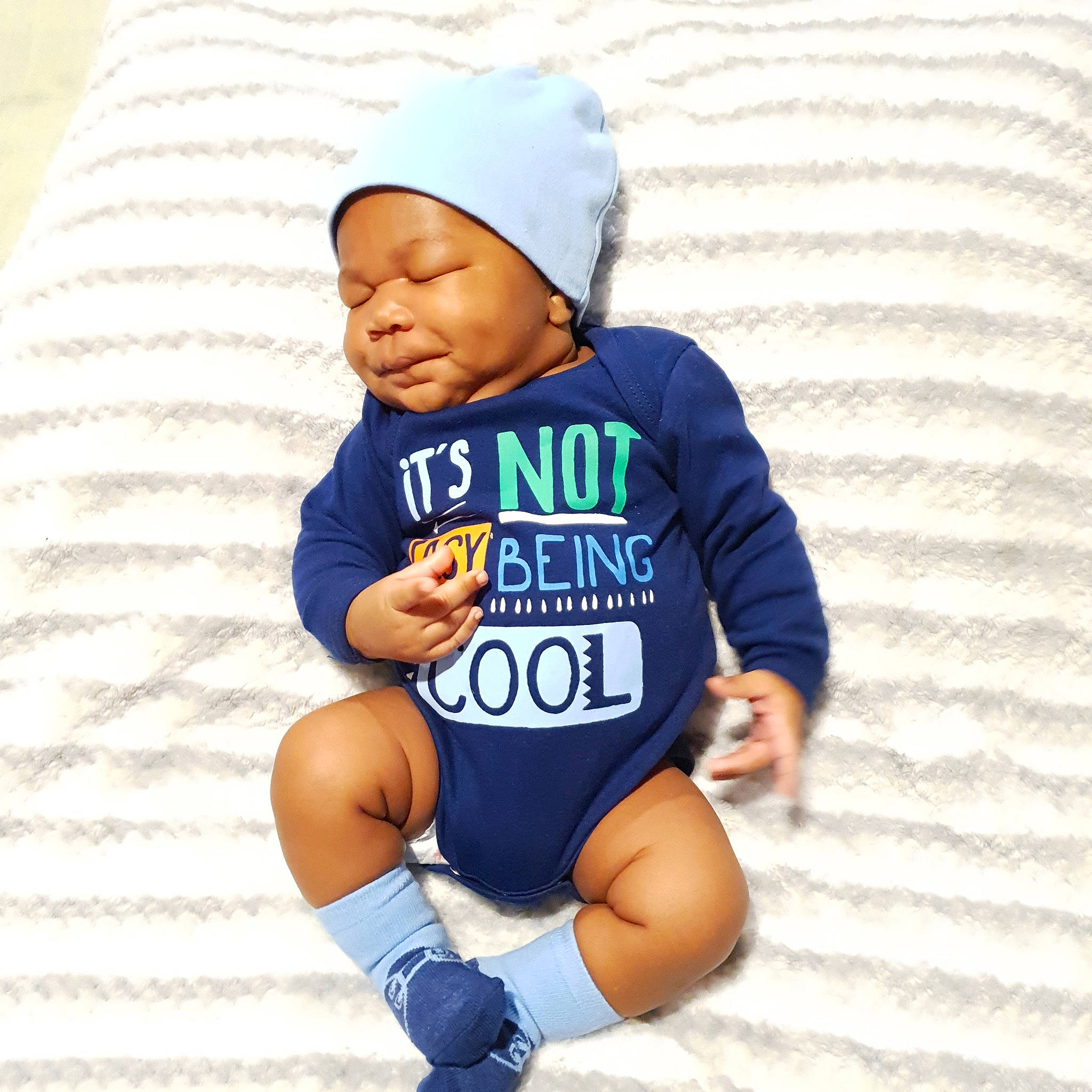 Osborne is registered to the contest to win money with this photo: baby, baby_toddler_clothing, beanie, child, clothing, cool, headgear, headwear, hood, hoodie, outerwear, person, product, sleeve, t_shirt, toddler
