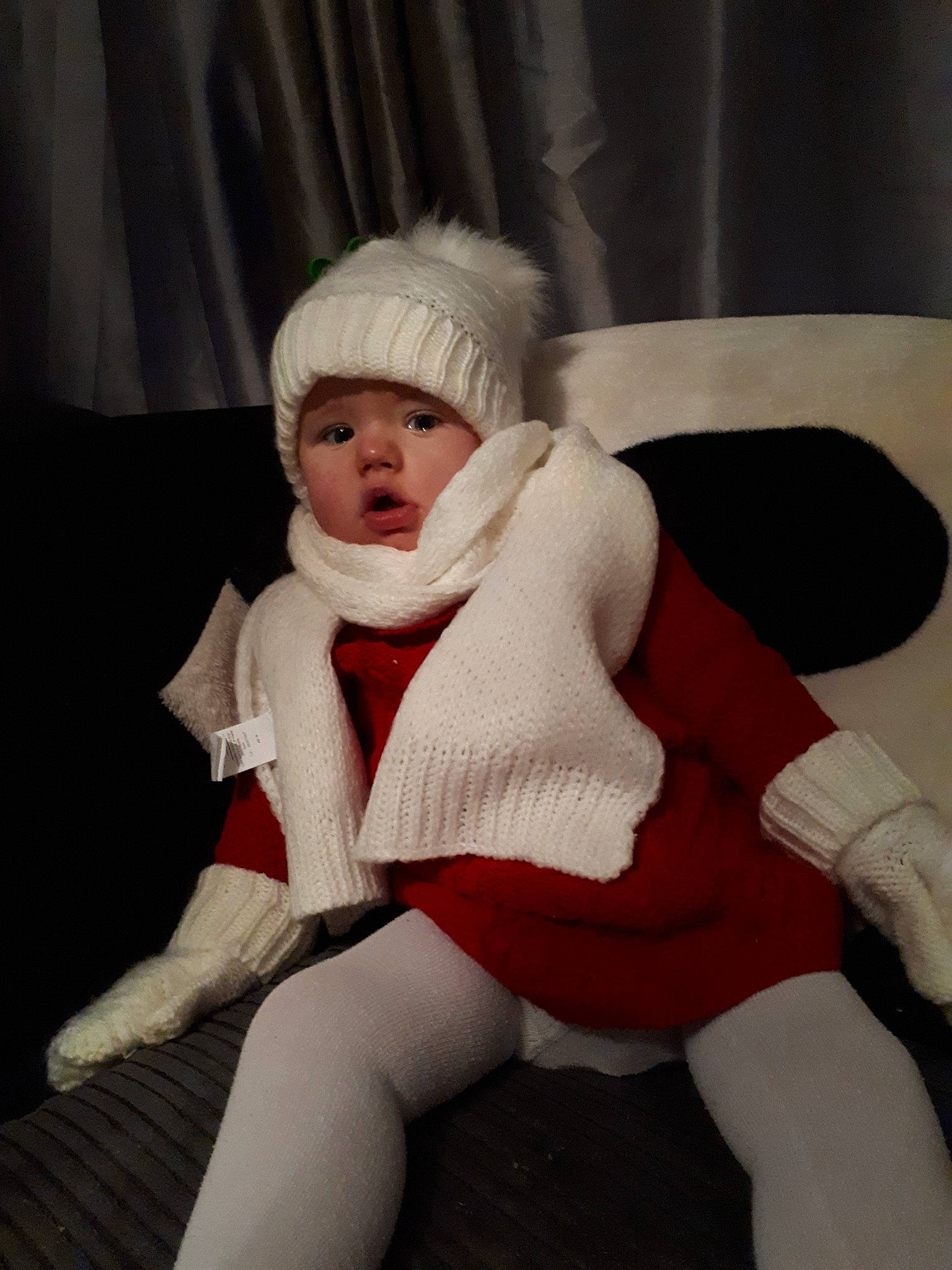 Lily is registered to the contest to win money with this photo: child, fur, headwear, leg, person, sitting, thigh