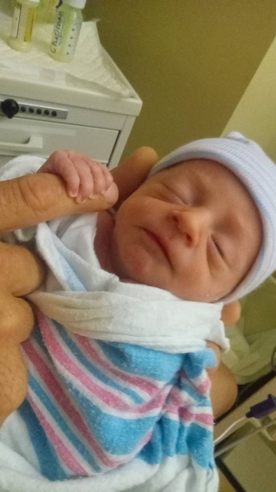 Hudson is registered to the contest to win money with this photo: baby, baby_products, baby_safety, baby_toddler_clothing, cheek, child, comfort, finger, gesture, hand, home_appliance, laundry_room, mouth, person, product, room, skin, thumb, toddler, washing_machine