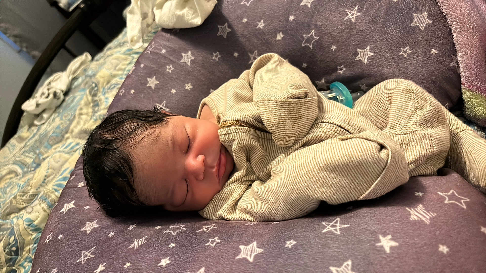 Ezra joined the competition — help win amazing prizes! baby, newborn, sleeping, infant, cozy, cushion, stars, purple, beige, clothing, bedroom, soft_texture, peaceful, portrait, child, resting, indoors, cute, toddler, face