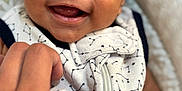 Ezra is registered to the contest to win money with this photo: baby, smiling, closeup, hand, face, infant, constellation_pattern, outfit, zipper, happy, cute, person, skin, child, newborn, joy, expression, indoor, fabric, playful