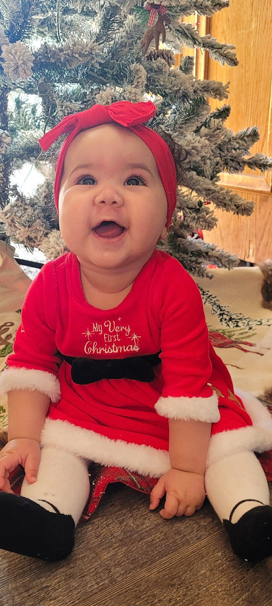 Ayla joined the competition — help win amazing prizes! baby, baby_laughing, baby_toddler_clothing, christmas_tree, event, face, facial_expression, happy, head, headwear, person, pink, plant, red, skin, sleeve, smile, standing, thigh, toddler